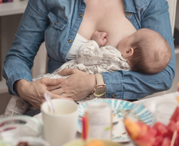 DG - A woman breastfeeding a newborn